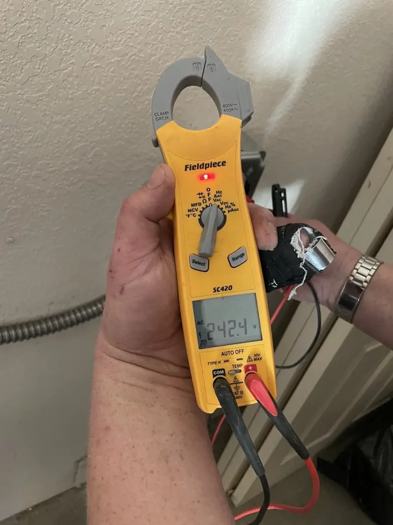 Voltage testing with clamp meter during Electrical Installation Services in Midlothian